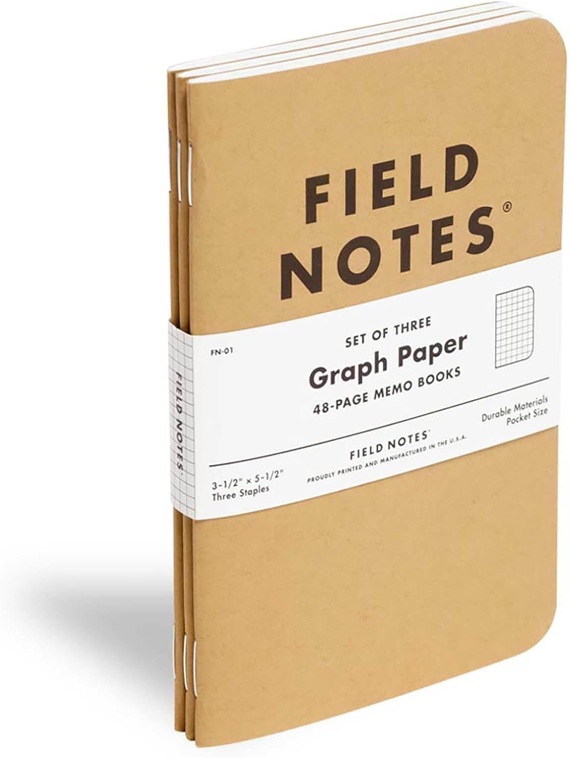 Three Field Notes graph paper memo books with the original kraft cover on a white background