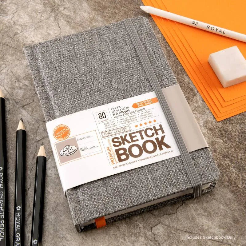 Gray sketchbook with a label on a textured surface with drawing tools.